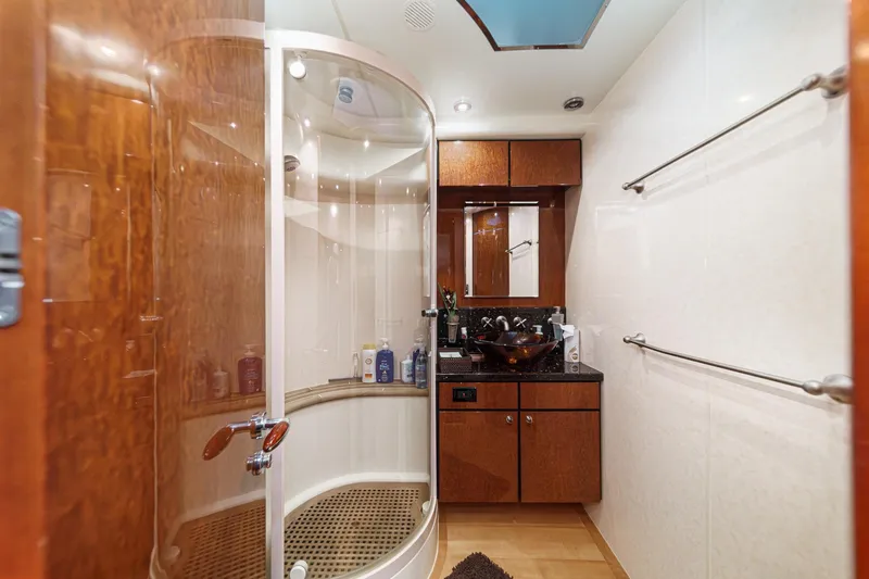 Slide: The Image of Luxurious bathroom on 2006 Fairline 74 Custom yacht with modern shower and elegant wood finishes. - 38