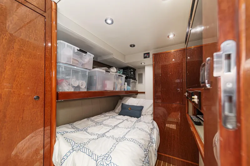 Slide: The Image of Cozy cabin interior of 2006 Fairline 74 Custom yacht with wooden finishes and storage. - 39