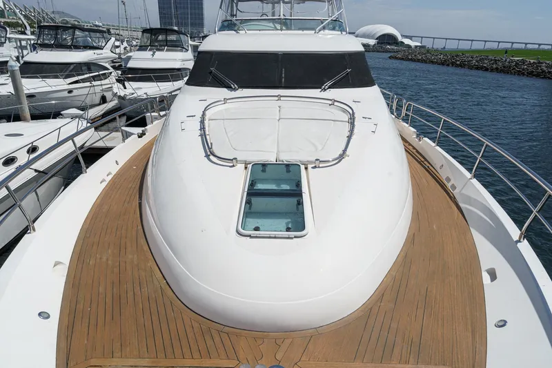 Slide: The Image of 2006 Fairline 74 Custom yacht docked, showcasing sleek design and spacious deck. - 5