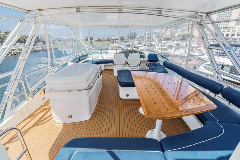 Slide: The Image of Luxurious 2006 Fairline 74 Custom yacht interior with seating and table, overlooking marina. - 7