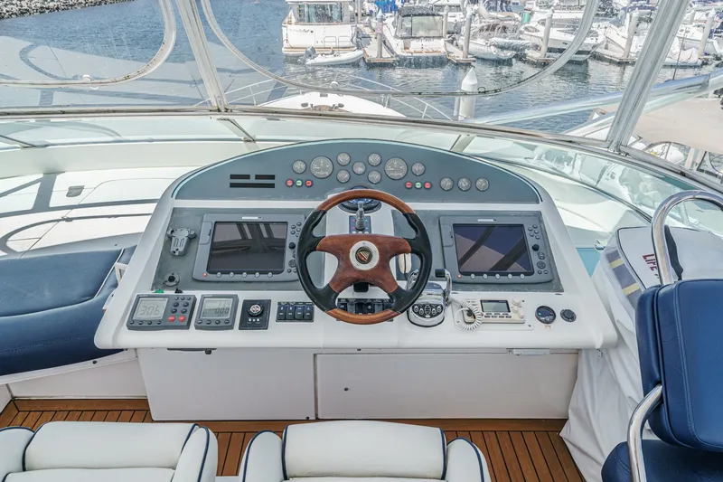 Slide: The Image of Helm of 2006 Fairline 74 Custom yacht with navigation controls and wooden steering wheel. - 9