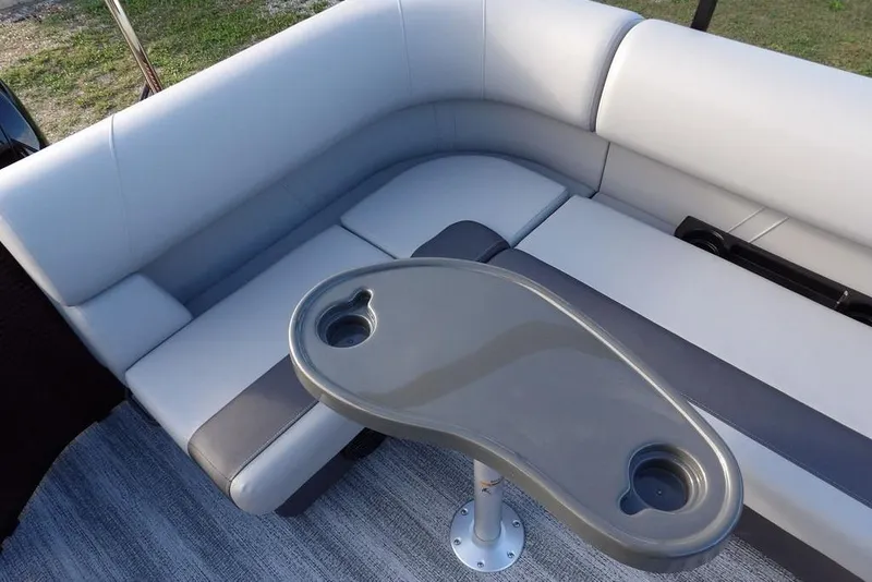 Slide: The Image of 2026 Bennington S L-Bench 22 SL boat seating with table and cup holders. - 22