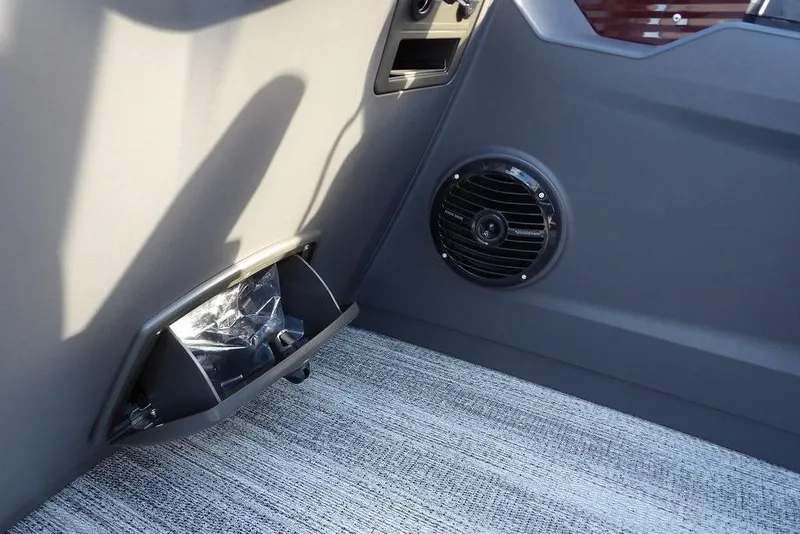 Slide: The Image of 2026 Bennington S L-Bench 22 SL interior with speaker and storage compartment. - 23