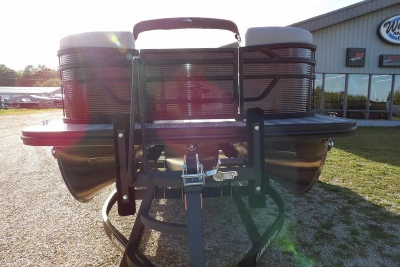 Slide: The Image of 2026 Bennington S L-Bench 22 SL pontoon boat on trailer, outdoor dealership view. - 3