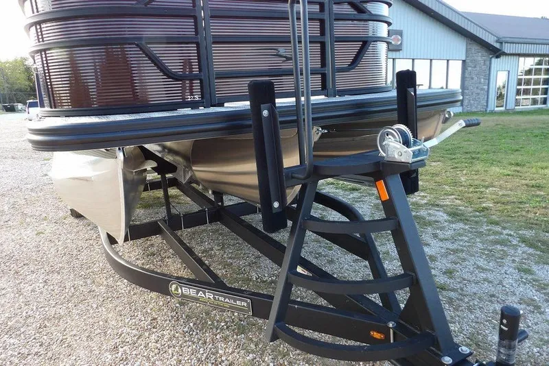 Slide: The Image of 2026 Bennington S L-Bench 22 SL pontoon boat on Bear trailer, parked outdoors. - 34