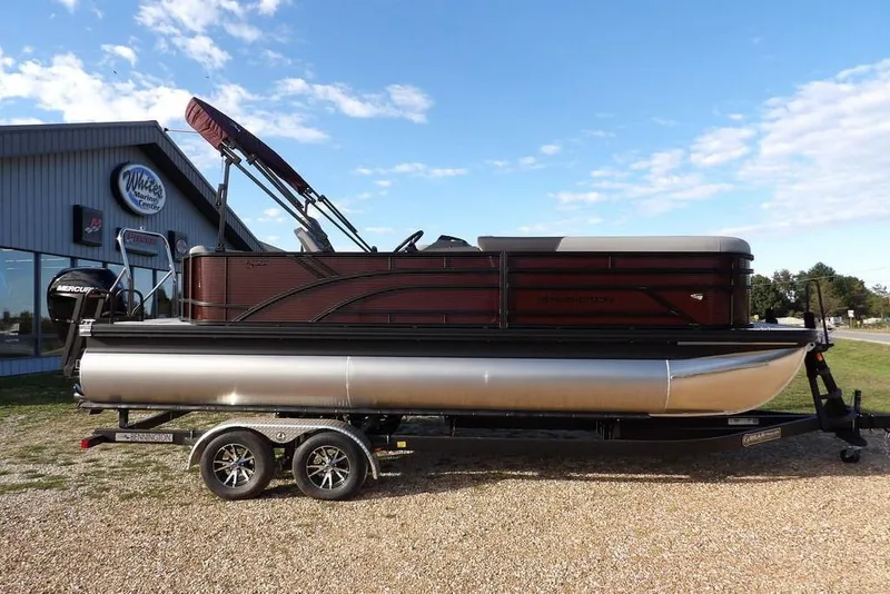 Slide: The Image of 2026 Bennington S L-Bench 22 SL pontoon boat on trailer, parked outdoors. - 4