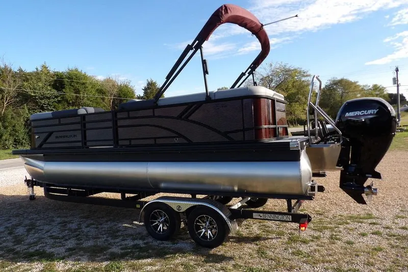 Slide: The Image of 2026 Bennington S L-Bench 22 SL pontoon boat on trailer with Mercury outboard motor. - 5