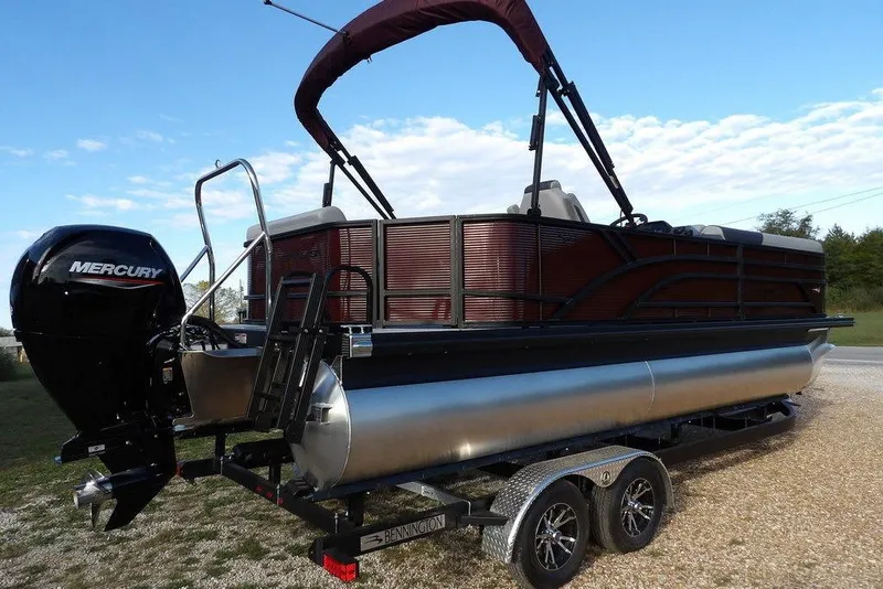 Slide: The Image of 2026 Bennington S L-Bench 22 SL pontoon boat with Mercury engine on trailer. - 6