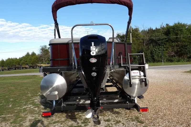 Slide: The Image of 2026 Bennington S L-Bench 22 SL pontoon boat with 150 HP motor, parked outdoors. - 8