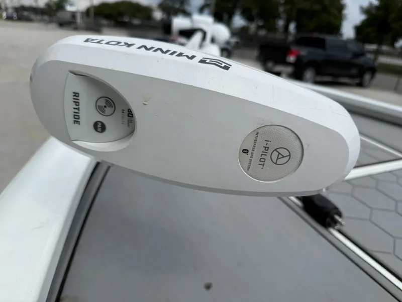 Slide: The Image of Avid 23 FS 2020 boat interior with beige seating and steering wheel. - 10