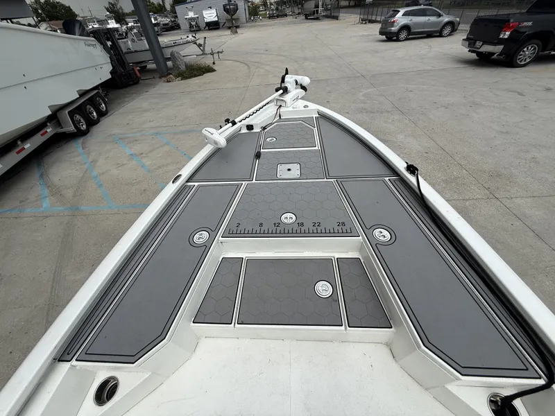 Slide: The Image of Open storage compartments on a 2020 Avid 23 FS boat, revealing life jacket and gear. - 17