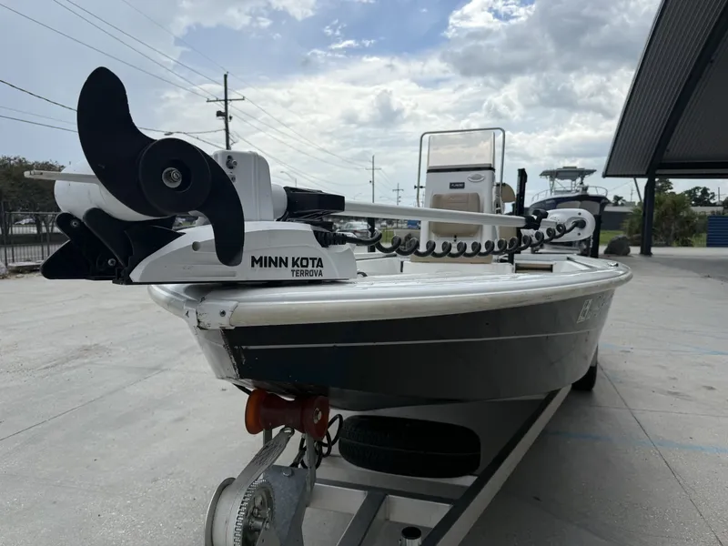 Slide: The Image of 2020 Avid 23 FS boat on trailer, parked outdoors under cloudy sky. - 3