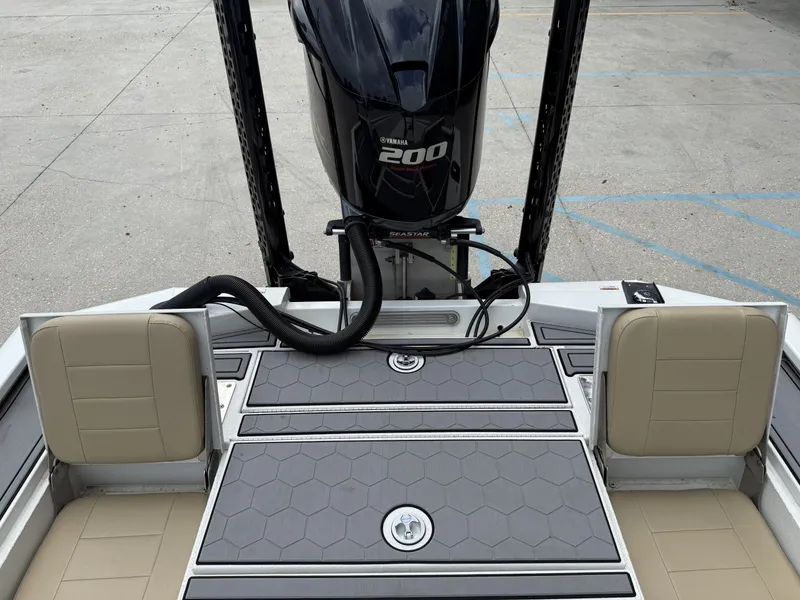 Slide: The Image of Avid 23 FS boat interior with open storage compartment and beige seating, 2020 model. - 8