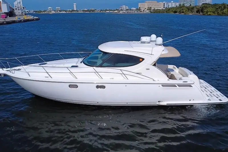 The Image of 2011 Tiara Yachts 4500 Sovran cruising on blue water near a cityscape. - 0