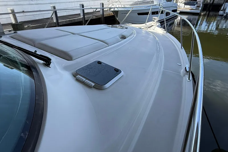 Slide: The Image of 2011 Tiara Yachts 4500 Sovran deck with sunpad and railing, docked at marina. - 10