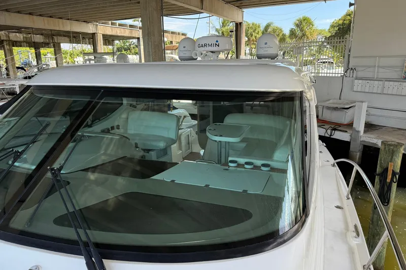 Slide: The Image of 2011 Tiara Yachts 4500 Sovran docked, featuring Garmin navigation equipment. - 13