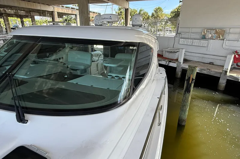 Slide: The Image of 2011 Tiara Yachts 4500 Sovran docked, showcasing sleek design and modern navigation equipment. - 15