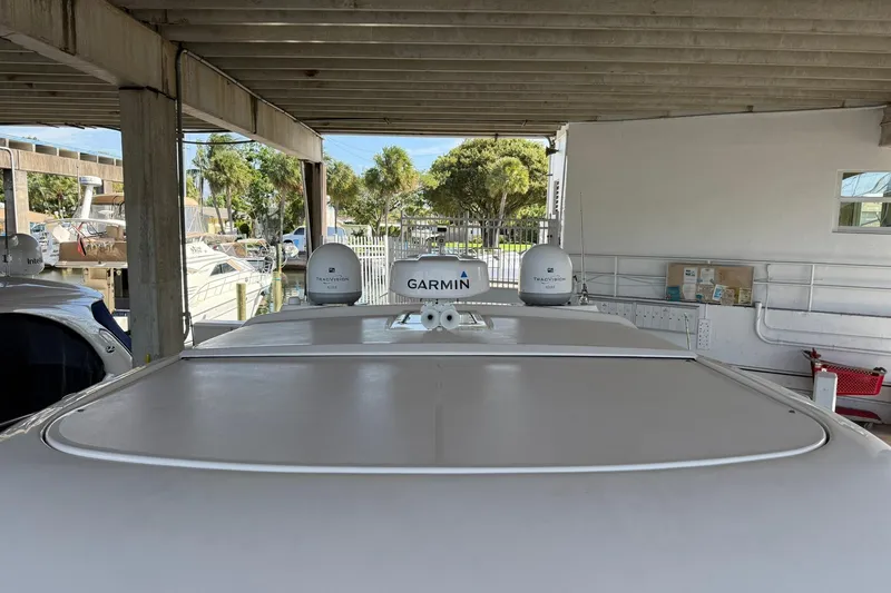 Slide: The Image of 2011 Tiara Yachts 4500 Sovran with Garmin equipment in a covered dock. - 16