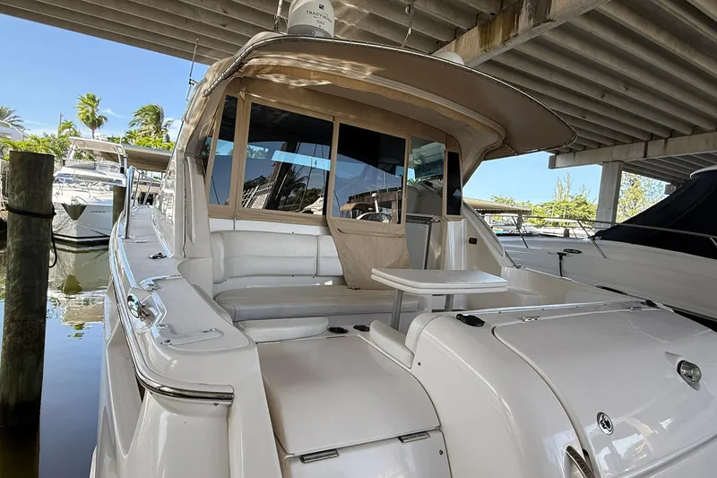 Slide: The Image of 2011 Tiara Yachts 4500 Sovran docked under a covered marina. - 17