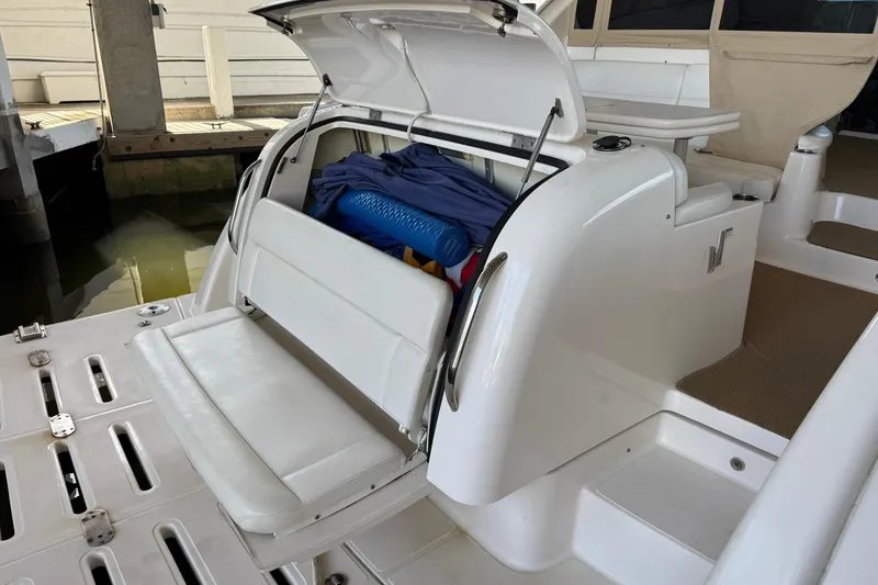 Slide: The Image of 2011 Tiara Yachts 4500 Sovran with open storage compartment at dock. - 19