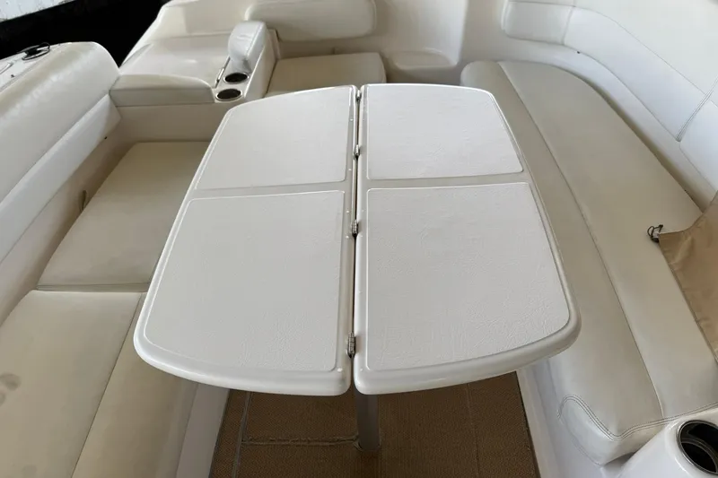 Slide: The Image of Interior of 2011 Tiara Yachts 4500 Sovran with white seating and foldable table. - 23