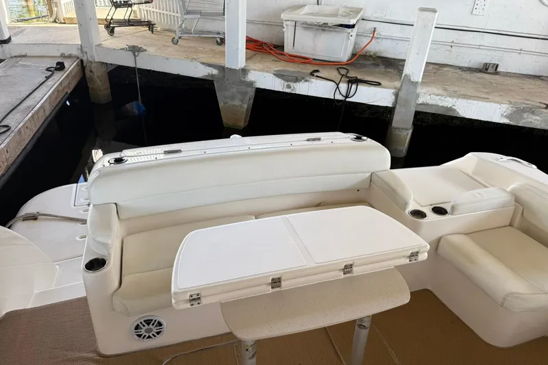 Slide: The Image of 2011 Tiara Yachts 4500 Sovran interior with white seating and table in docked setting. - 24