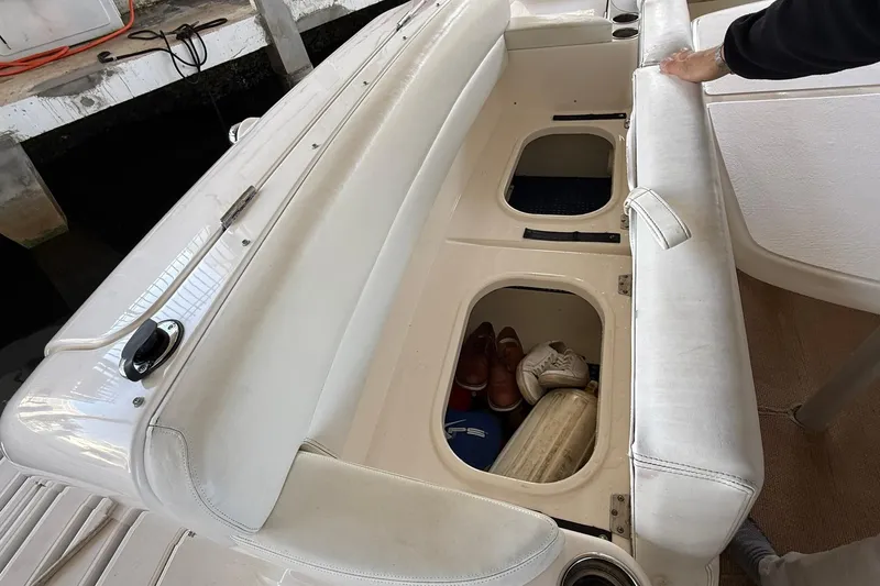 Slide: The Image of 2011 Tiara Yachts 4500 Sovran with open storage compartments and white seating. - 25