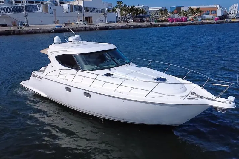 Slide: The Image of 2011 Tiara Yachts 4500 Sovran cruising in a marina, showcasing sleek design and luxury. - 3