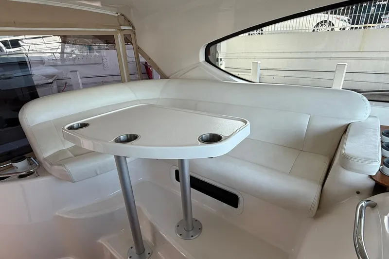 Slide: The Image of Interior seating area of 2011 Tiara Yachts 4500 Sovran with white upholstery and table. - 34