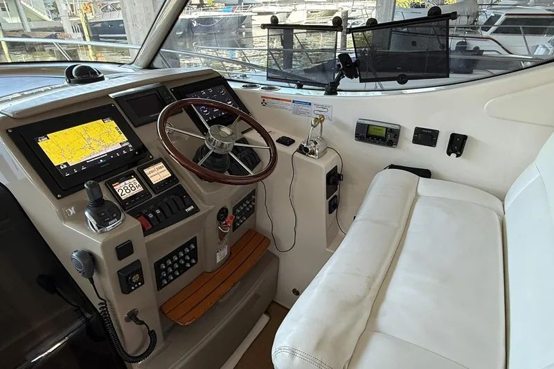 Slide: The Image of 2011 Tiara Yachts 4500 Sovran helm with navigation screens and steering wheel. - 35