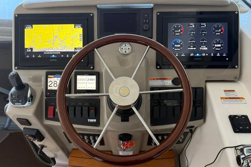 Slide: The Image of Cockpit of 2011 Tiara Yachts 4500 Sovran with Garmin navigation displays and controls. - 38