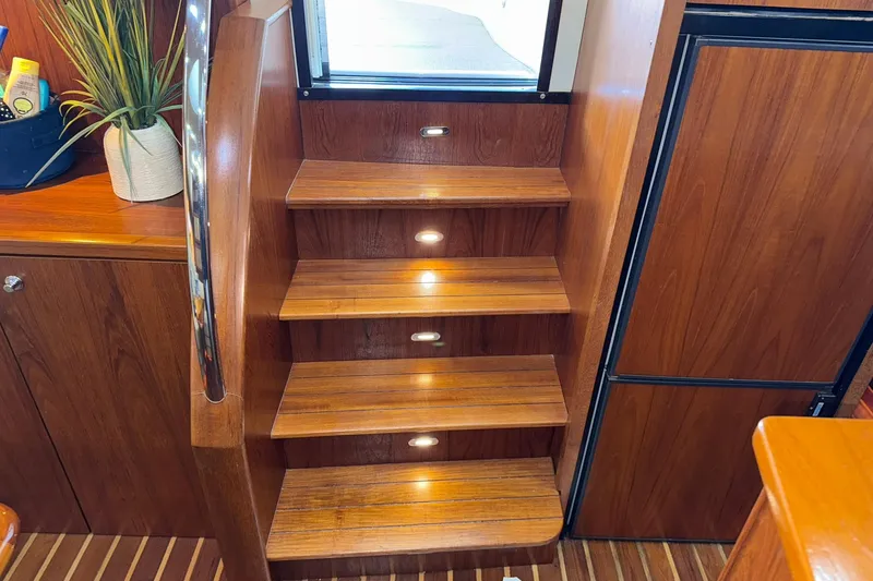 Slide: The Image of Wooden interior stairs with lighting on a 2011 Tiara Yachts 4500 Sovran. - 43
