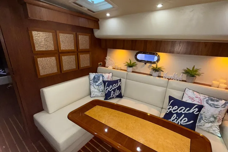 Slide: The Image of Interior of 2011 Tiara Yachts 4500 Sovran with elegant seating and decorative pillows. - 46