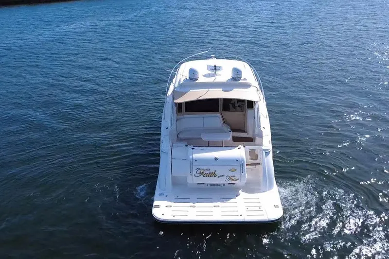 Slide: The Image of 2011 Tiara Yachts 4500 Sovran cruising on open water, rear view. - 5