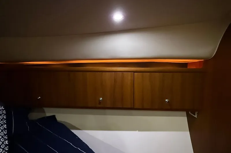 Slide: The Image of Interior cabin of 2011 Tiara Yachts 4500 Sovran with wooden cabinets and ambient lighting. - 51