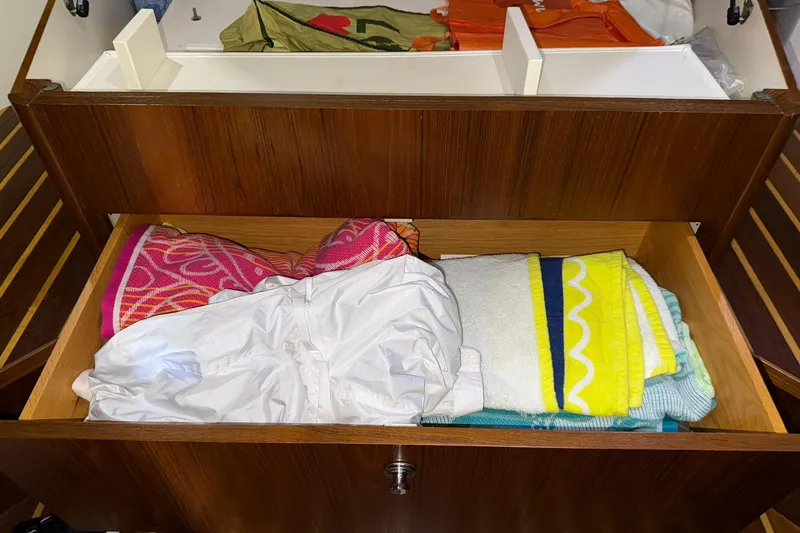 Slide: The Image of Drawer in 2011 Tiara Yachts 4500 Sovran with colorful towels and clothing. - 55