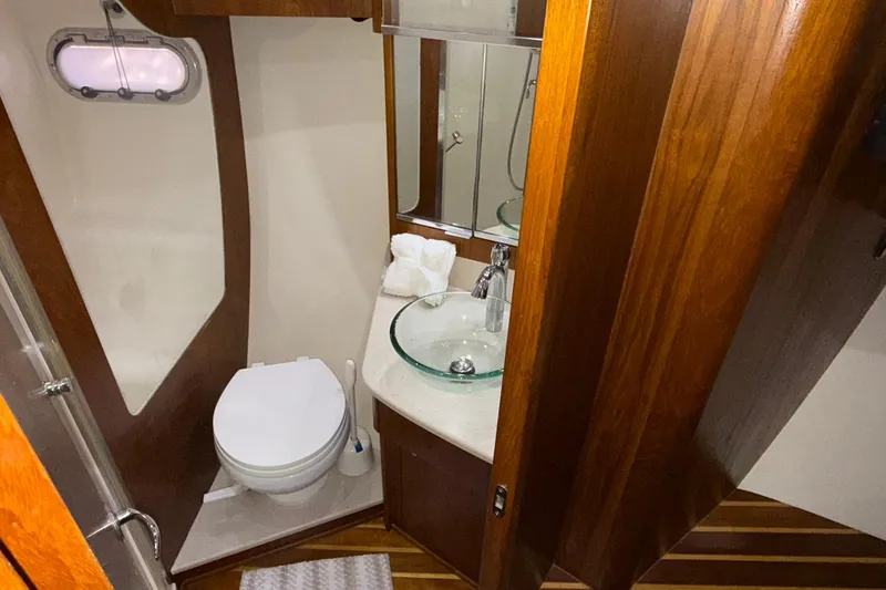 Slide: The Image of Luxurious bathroom in 2011 Tiara Yachts 4500 Sovran with wood accents and modern fixtures. - 56