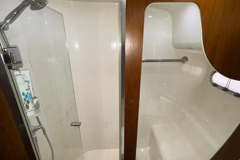 Slide: The Image of Luxurious shower area in 2011 Tiara Yachts 4500 Sovran, featuring glass door and wooden accents. - 58