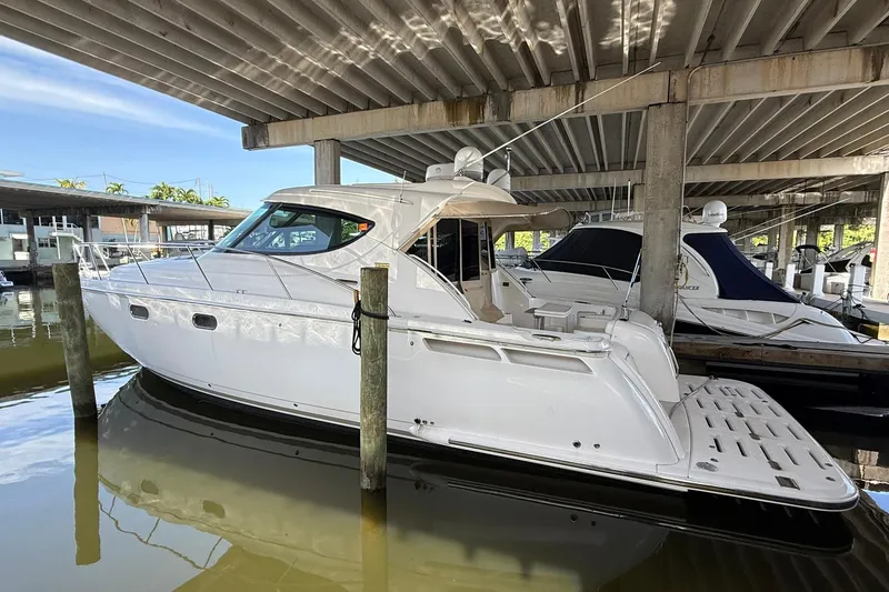Slide: The Image of 2011 Tiara Yachts 4500 Sovran docked under a covered marina. - 6