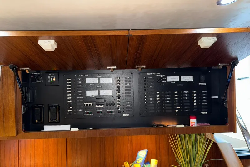 Slide: The Image of Electrical panel of 2011 Tiara Yachts 4500 Sovran, showcasing AC and DC systems. - 60