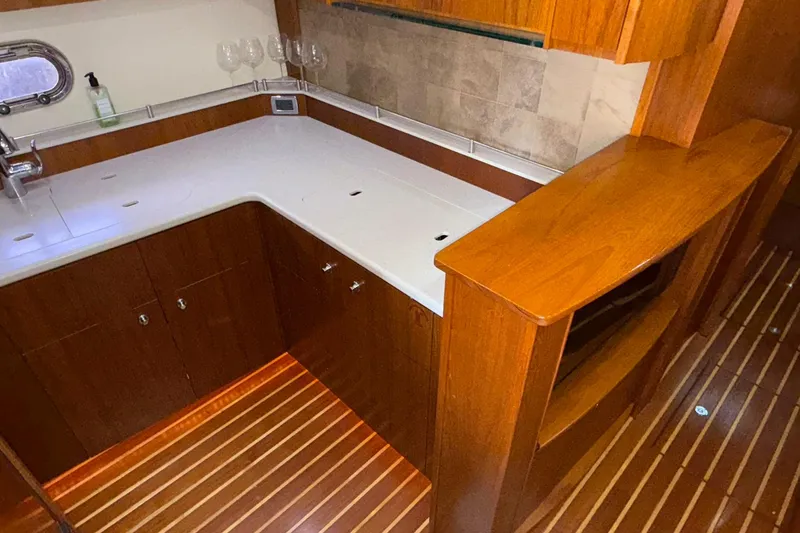 Slide: The Image of Luxurious 2011 Tiara Yachts 4500 Sovran kitchen with wood cabinetry and modern amenities. - 62