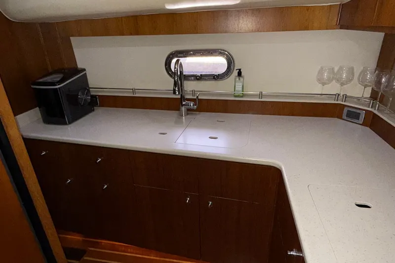 Slide: The Image of 2011 Tiara Yachts 4500 Sovran galley with modern countertop and sink. - 63