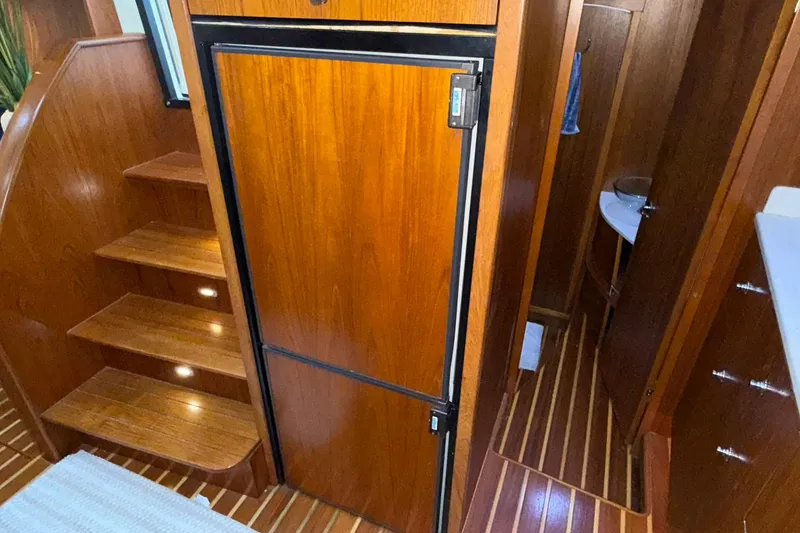 Slide: The Image of Interior of 2011 Tiara Yachts 4500 Sovran, featuring wooden stairs and cabinetry. - 65