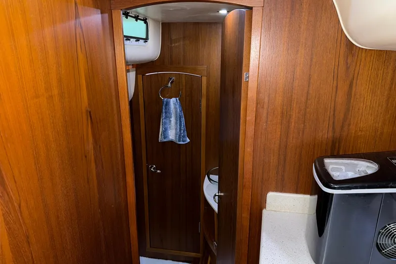 Slide: The Image of Interior of 2011 Tiara Yachts 4500 Sovran with wooden cabinetry and compact amenities. - 68