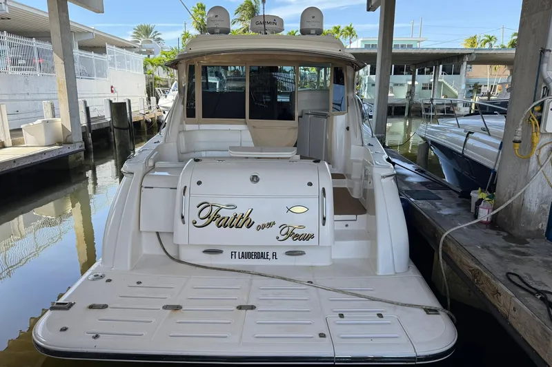 Slide: The Image of 2011 Tiara Yachts 4500 Sovran docked, featuring "Faith over Fear" text on the stern. - 7