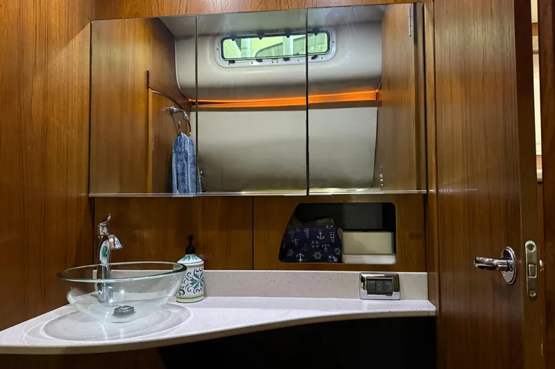 Slide: The Image of Luxurious bathroom in 2011 Tiara Yachts 4500 Sovran with glass sink and mirrored cabinet. - 70