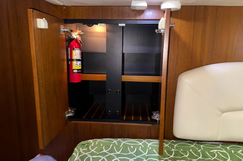 Slide: The Image of Open wooden cabinet with fire extinguisher inside Tiara Yachts 4500 Sovran, 2011 model. - 78