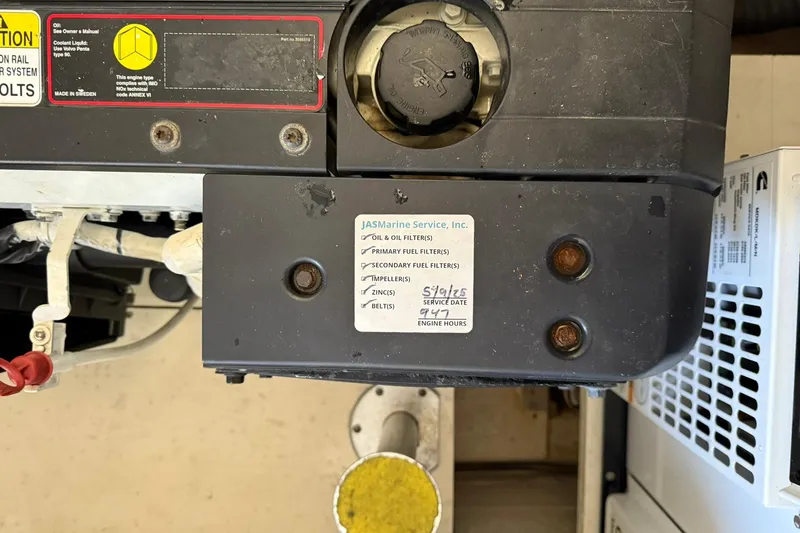 Slide: The Image of Engine compartment of a 2011 Tiara Yachts 4500 Sovran with service label visible. - 83