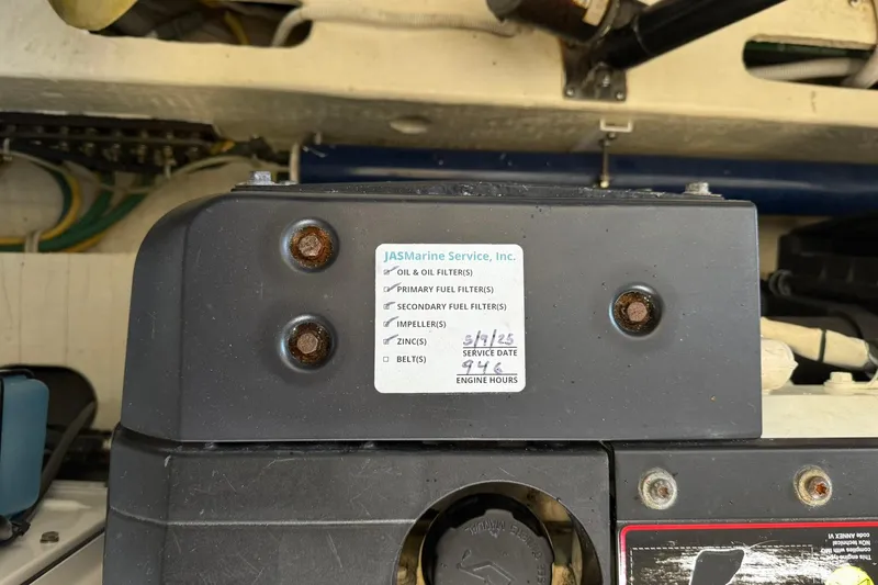 Slide: The Image of Engine compartment of a 2011 Tiara Yachts 4500 Sovran with service label details. - 84