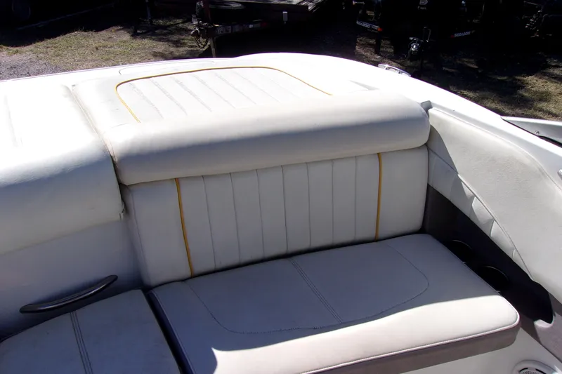 Slide: The Image of 2005 Cobalt 200 boat interior with white cushioned seating and yellow accents. - 11